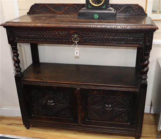 A late Victorian carved oak buffet, W.102cm, D.45cm, H.115cm.